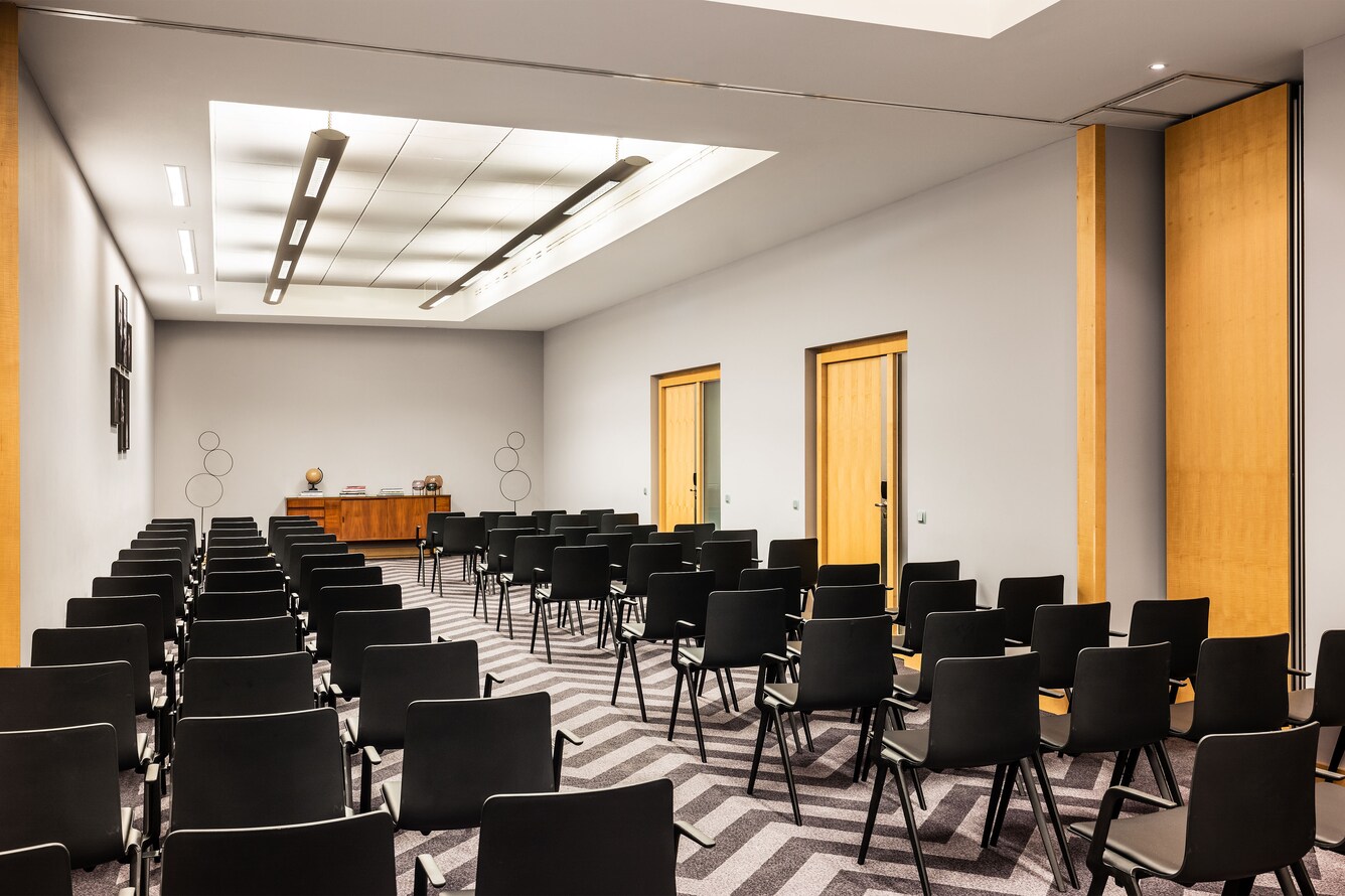 conference room with rows of black chairs