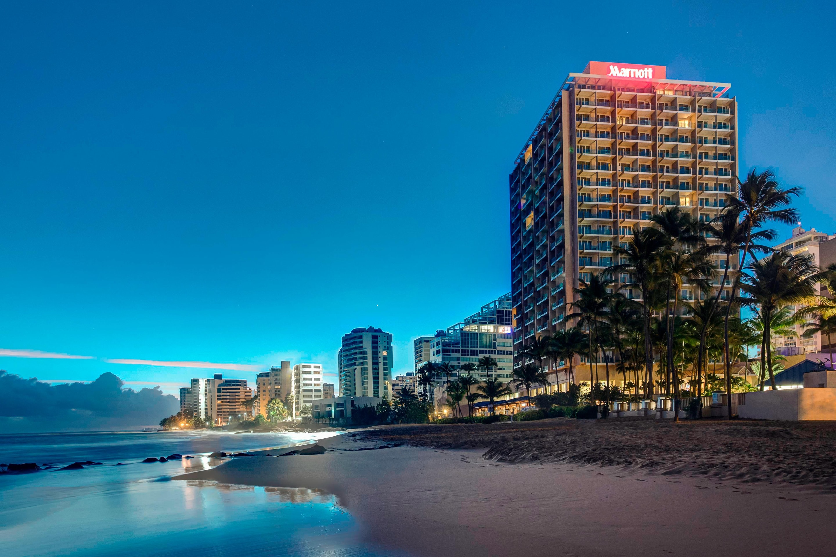 Exterior of hotel and beach at night