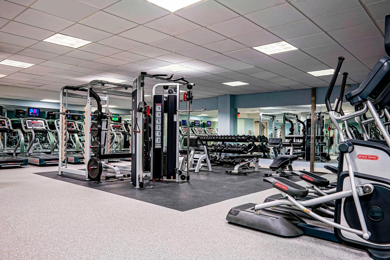Fitness Center with treadmills, ellipticals, weight machines and free weights