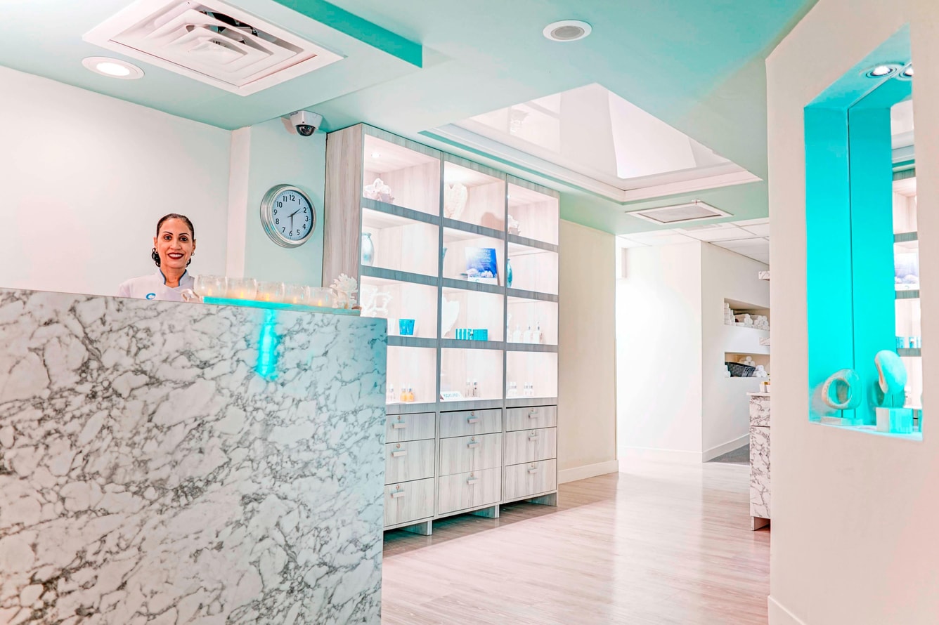 Woman at front desk of spa entrance