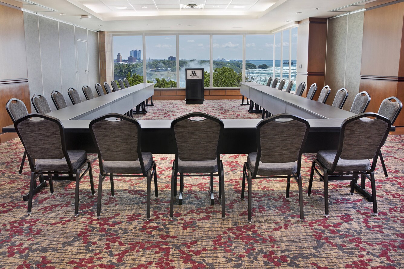 Long U shaped table setting with falls in the background