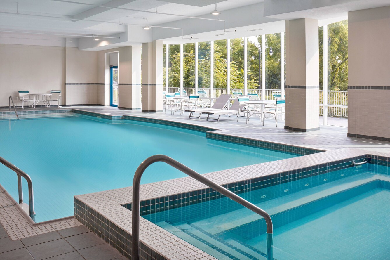 pool with floor to ceiling windows viewing a courtyard