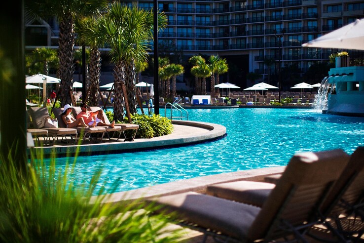 View of pool from cabana and lounge area, poolside.