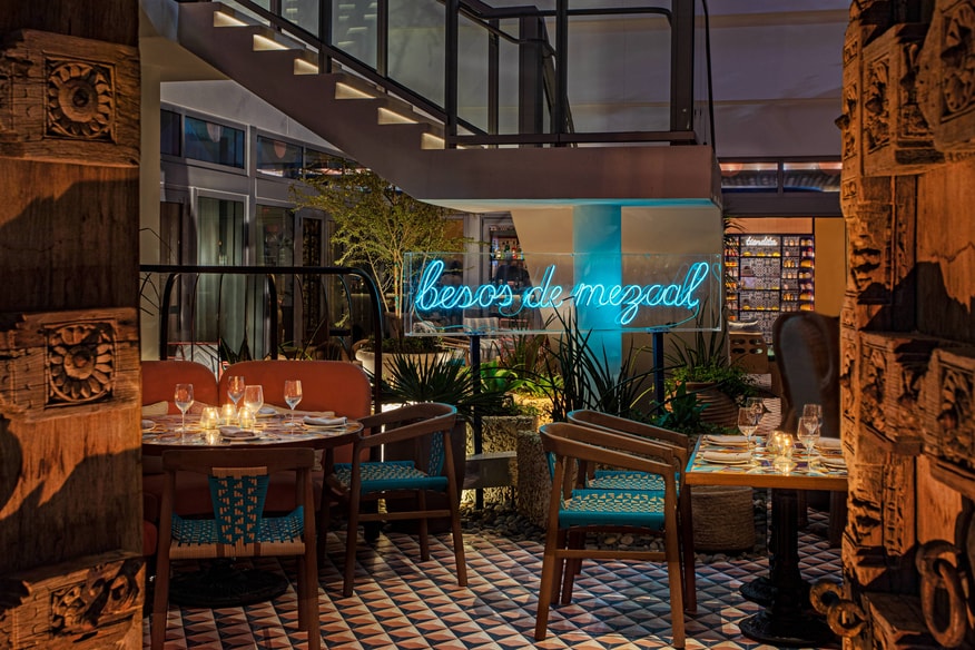 Como Como seafood restaurant with mood lighting and teal accents.