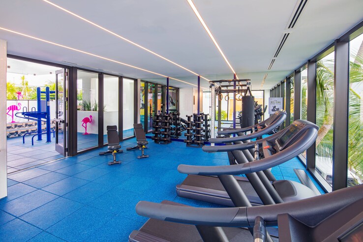 Moxy miami fitness center treadmills with floor-to-ceiling glass windows.