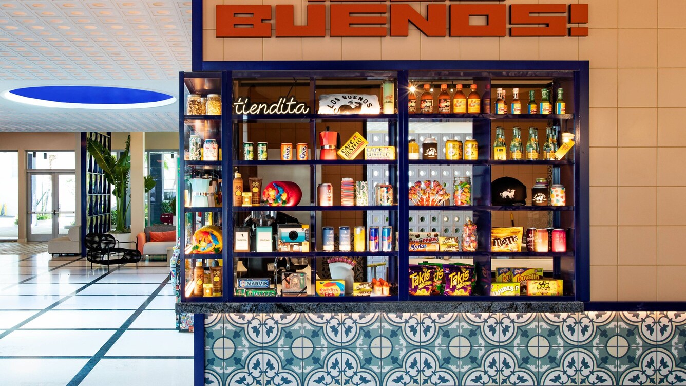 Shopfront window with colorful goods on display.