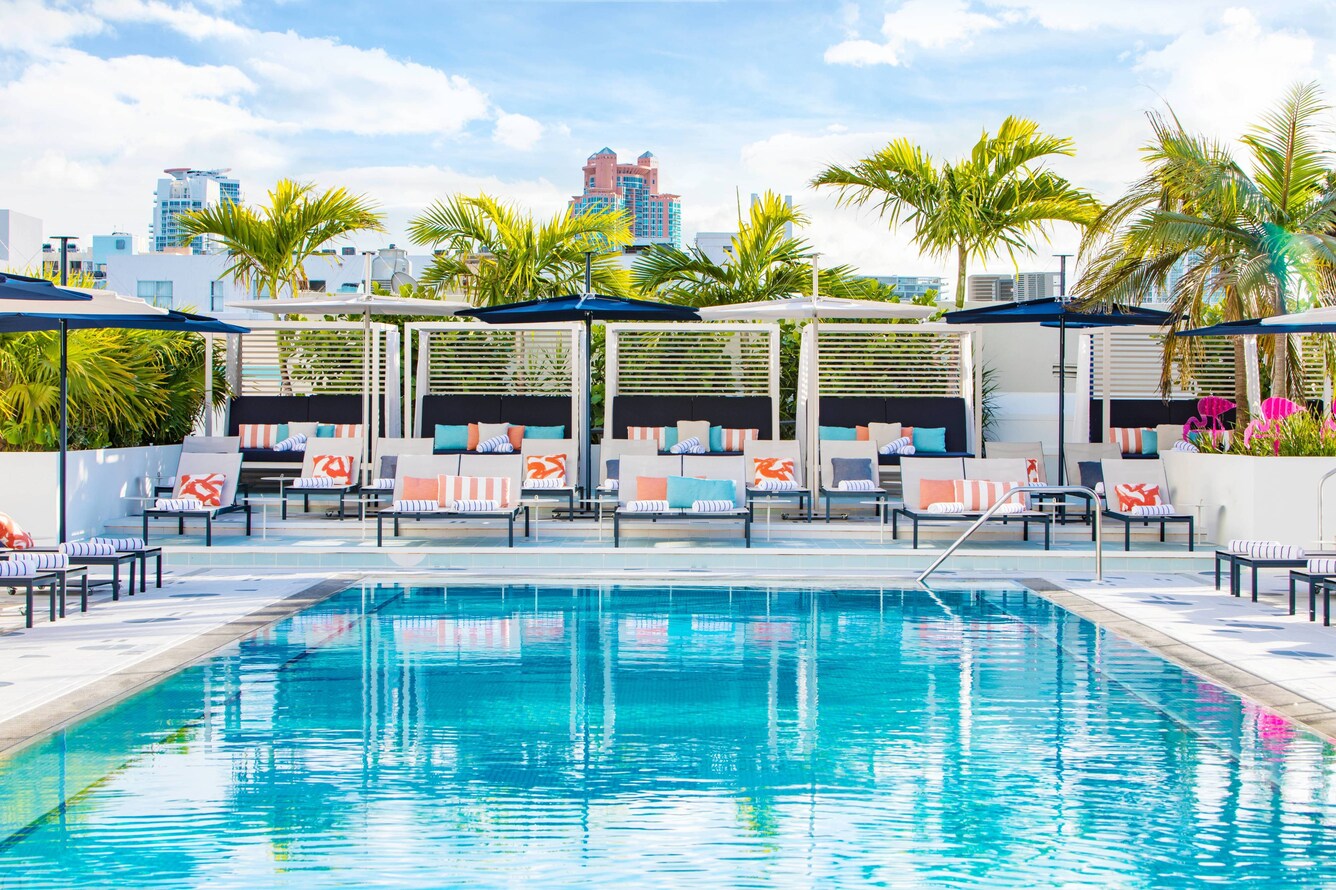 South Beach moxy miami pool deck with chairs, umbrellas, and cabanas