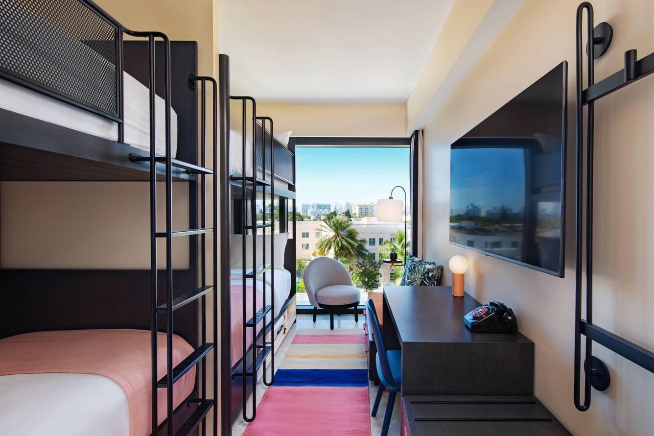 Quad bunk beds with pink bedding and decor with floor to ceiling views