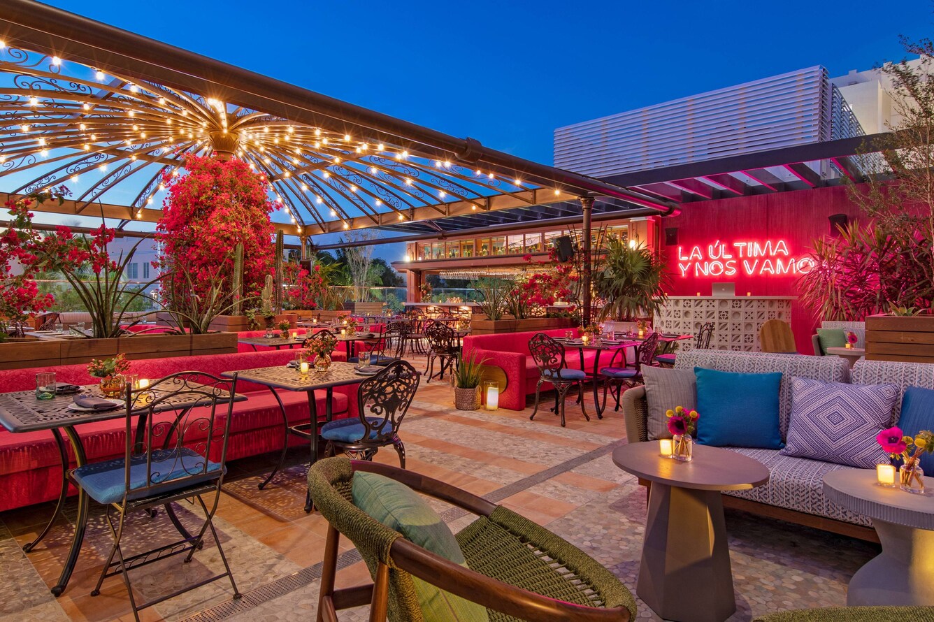 Serena Bar outdoor seating at dusk.