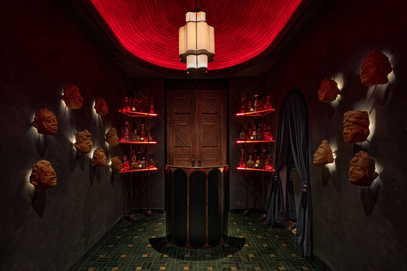 Mezcalista tequilla tasting room with dark tones, low lights and mask decorations