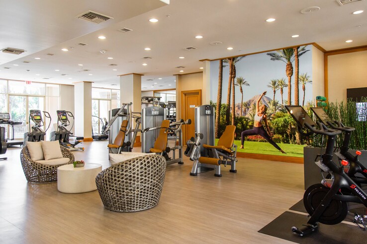 An assortment of exercise equipment and seating inside the fitness center.
