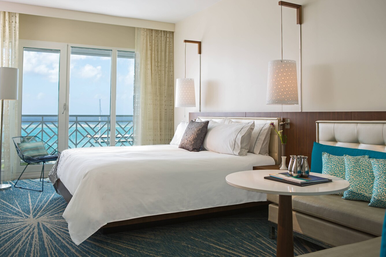 bed with view of ocean through balcony door