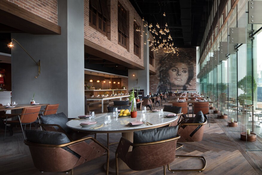 Basta restaurant dining tables and mural of woman