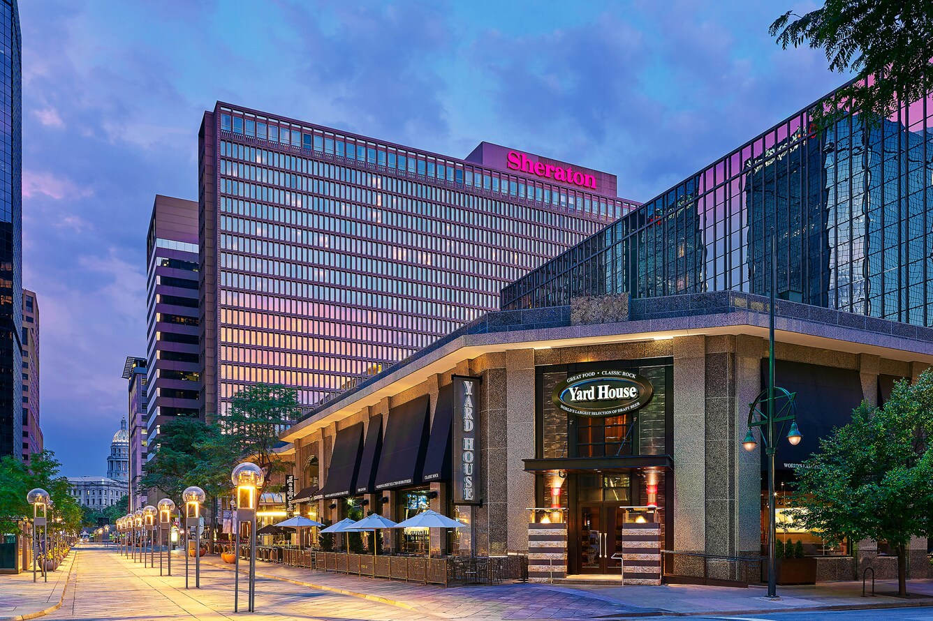 Restaurant on street with hotel in the background.