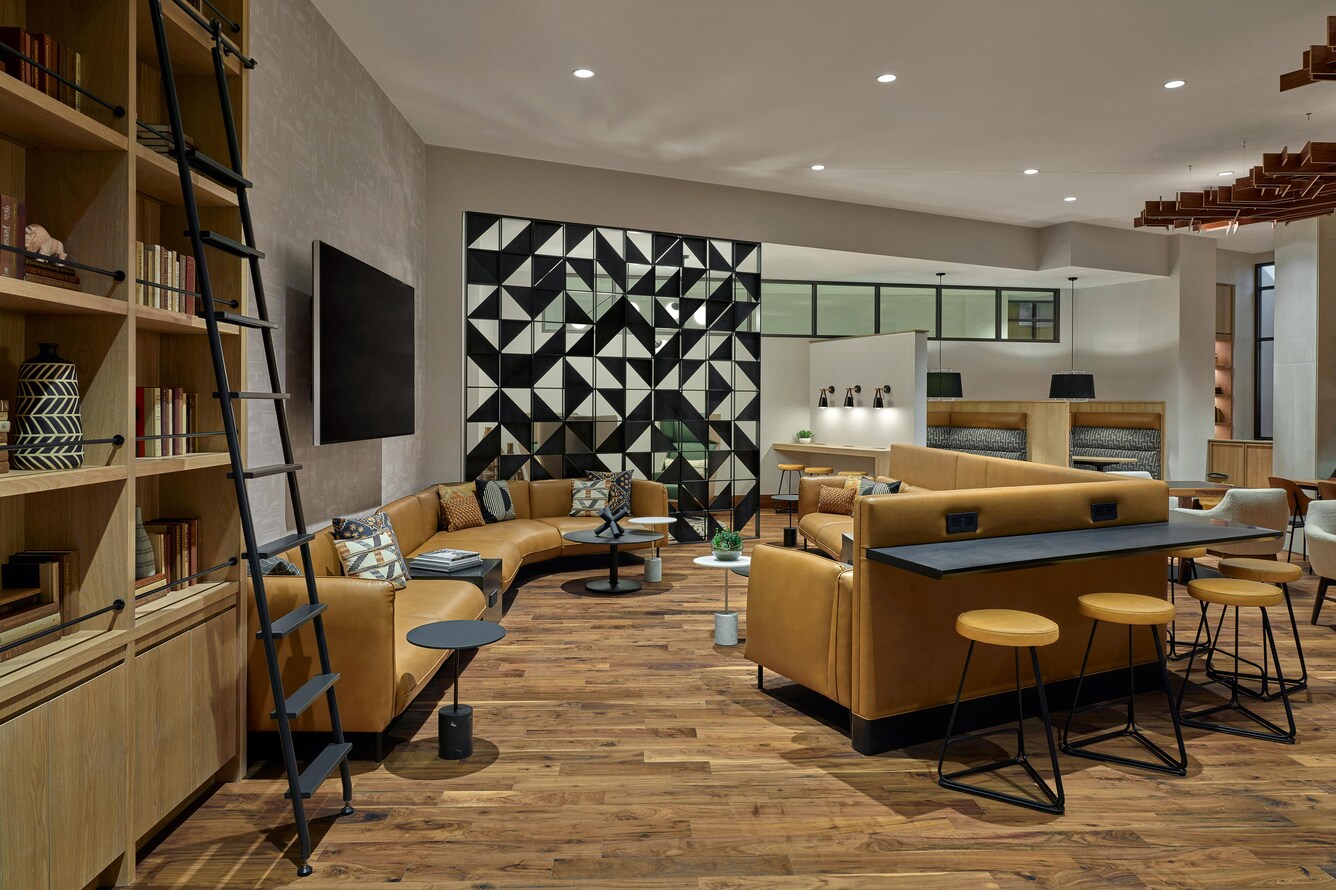 Club area with seating and bookshelf.