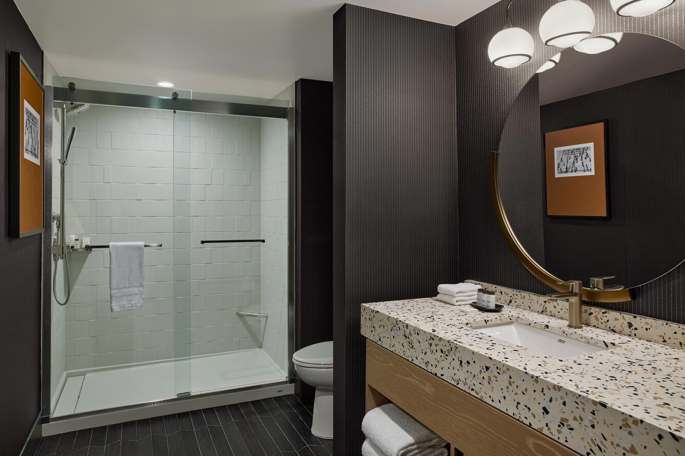 Large bathroom with vanity, and walk-in shower.