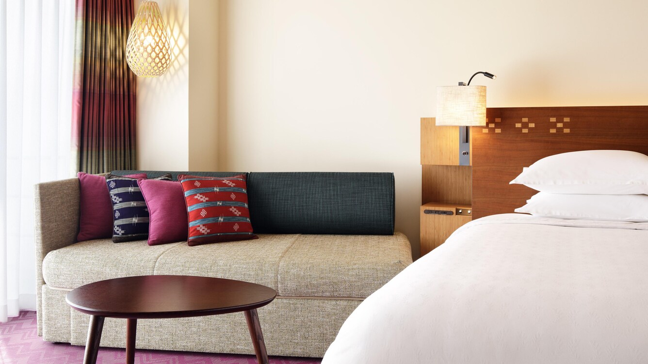 South tower guestroom with lounge seating and bed