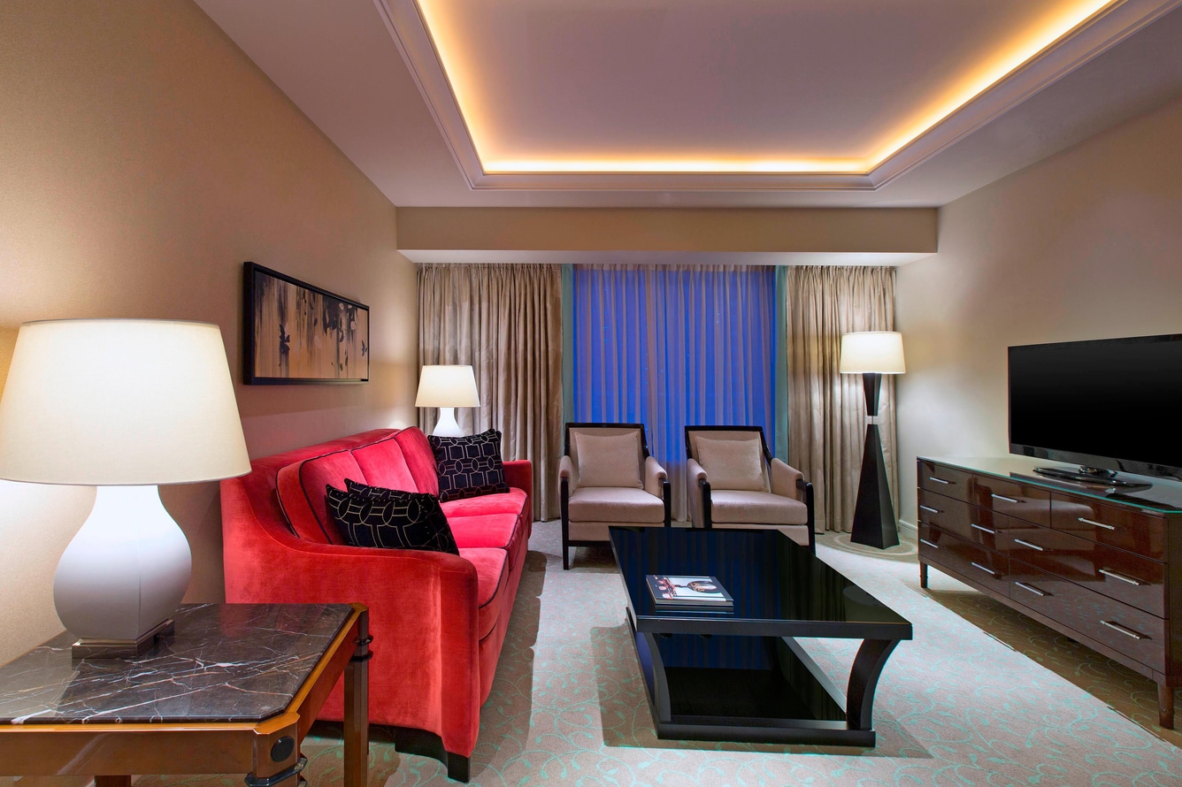 Executive suite club access room living area with seating and tv