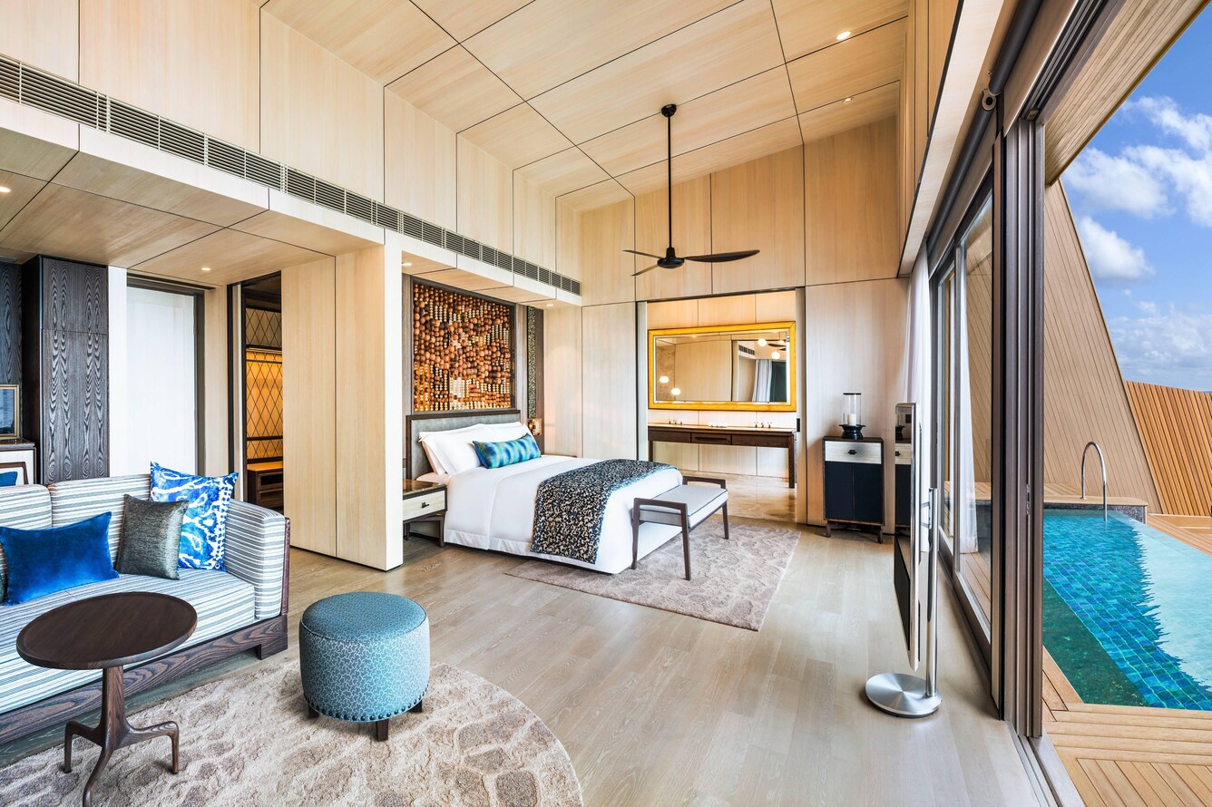Large open room with Double bed facing a full wall of windows overlooking the Sea.