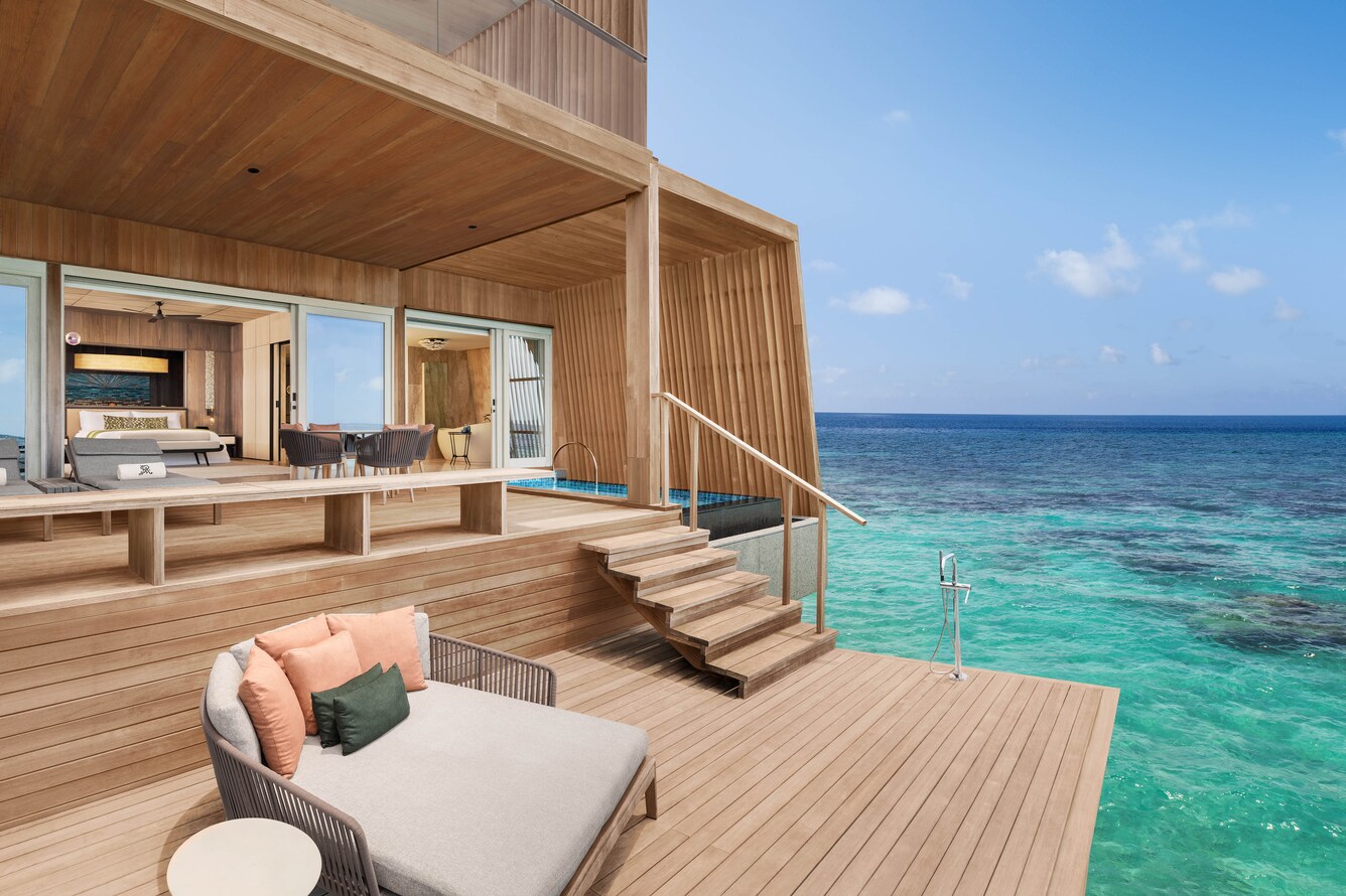 Large deck over the Ocean with lounge and stairs up to the villa