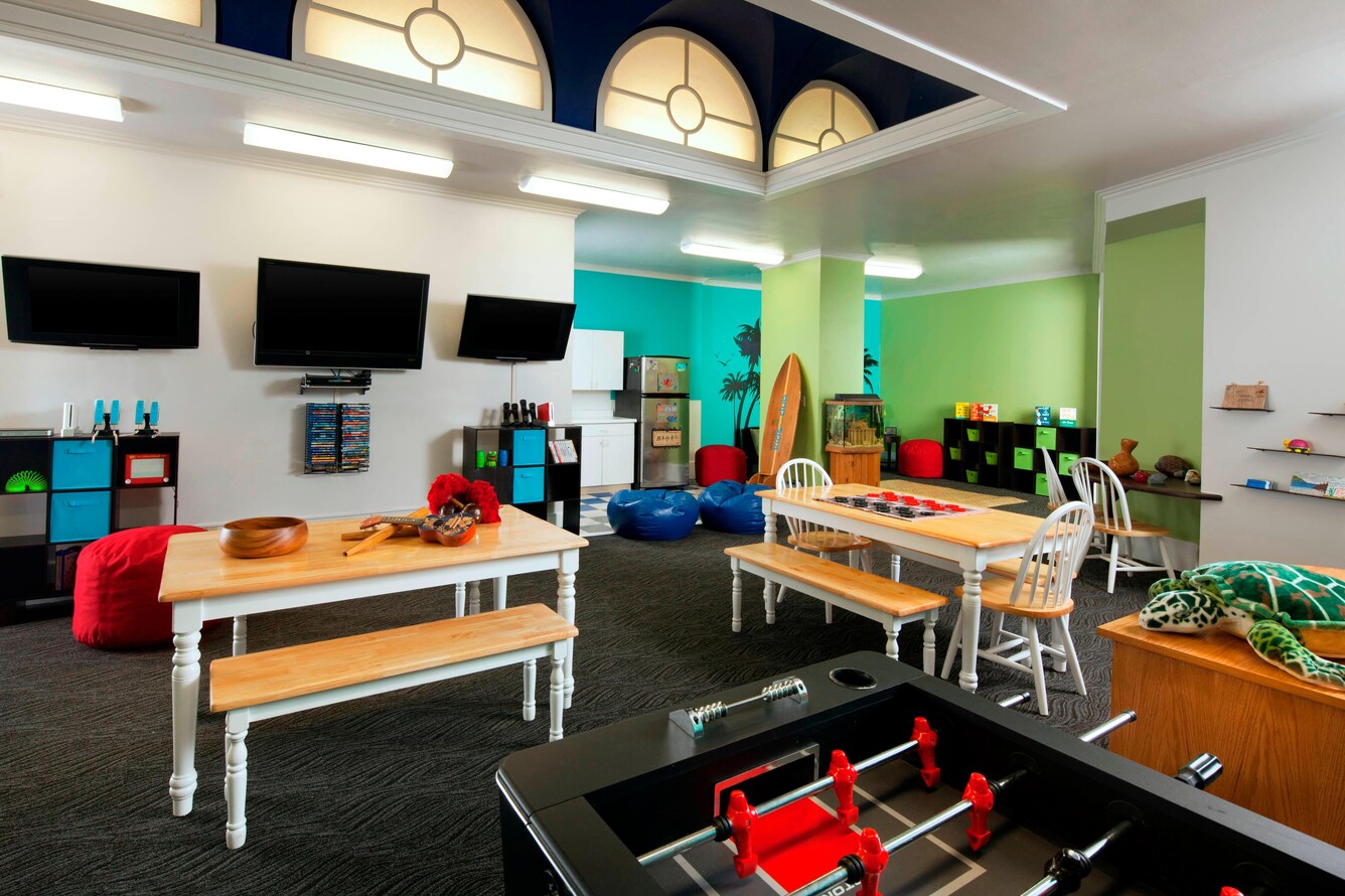 Kids Club interior with tables, games and flat screen televisions