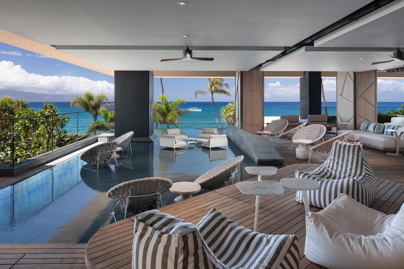 Lanai with outdoor furniture and a view of the ocean beyond.