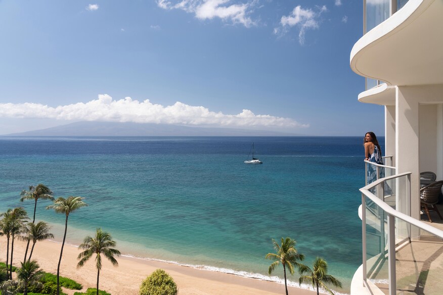 Resort Exterior balcony overlooking the beach and palm trees