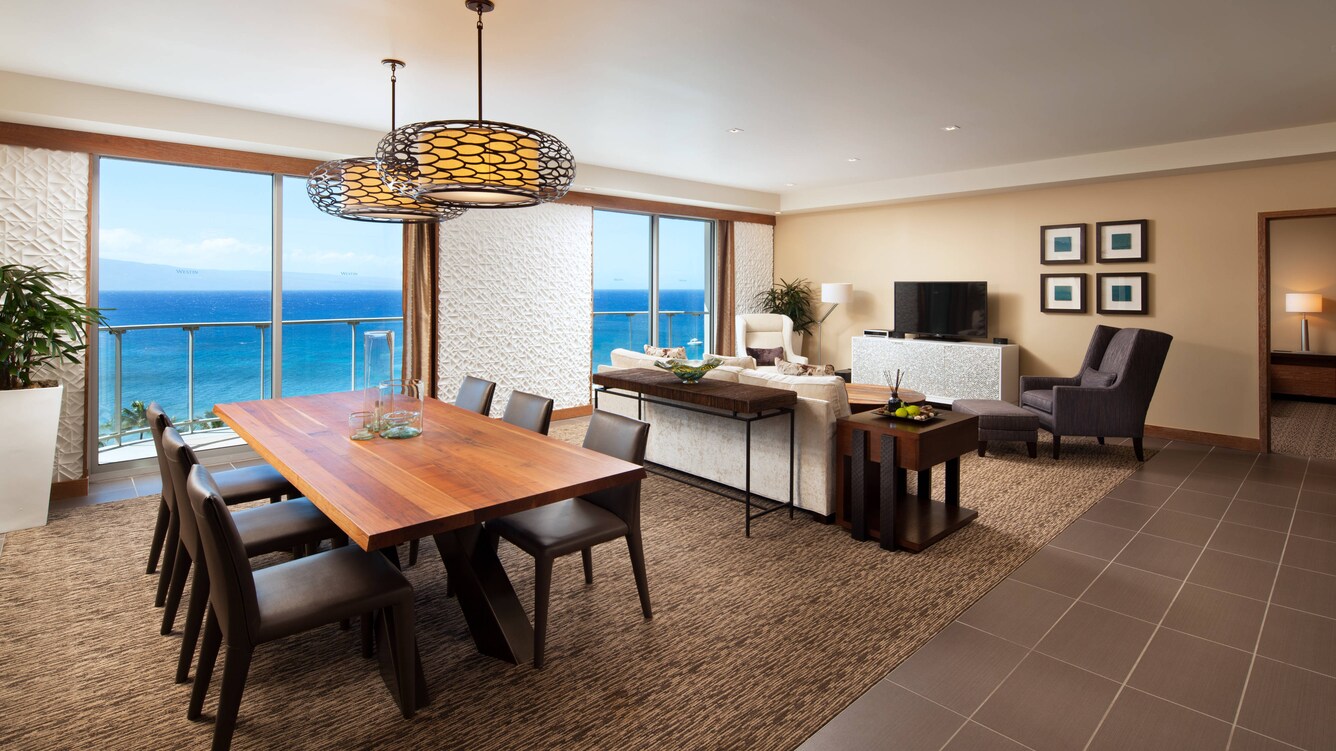 Presidential Suite dining table and chairs with a view of the living space.