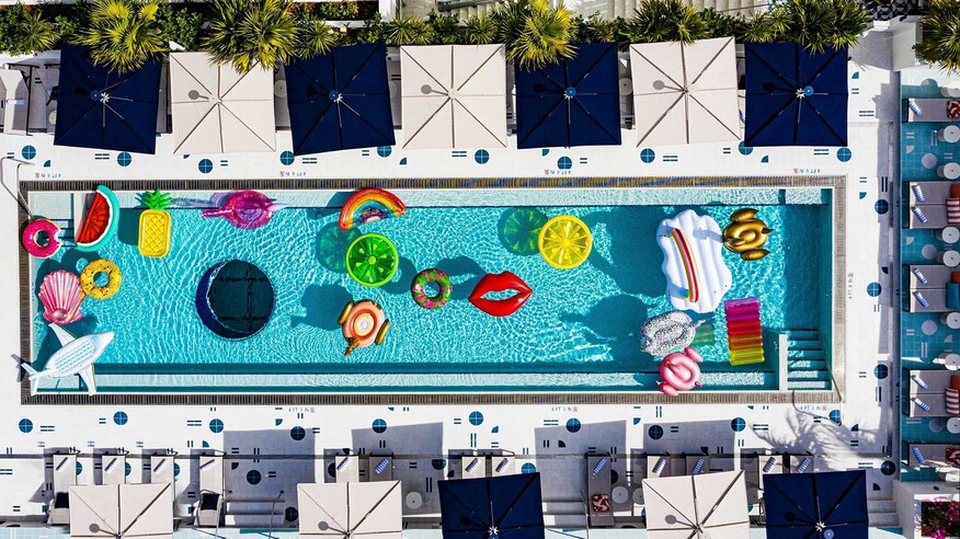 Moxy south beach outdoor pool with pink floatie and window on pool floor.