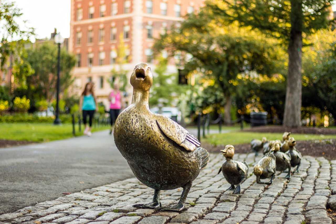 Sculpture of mother duck and ducklings at the park.