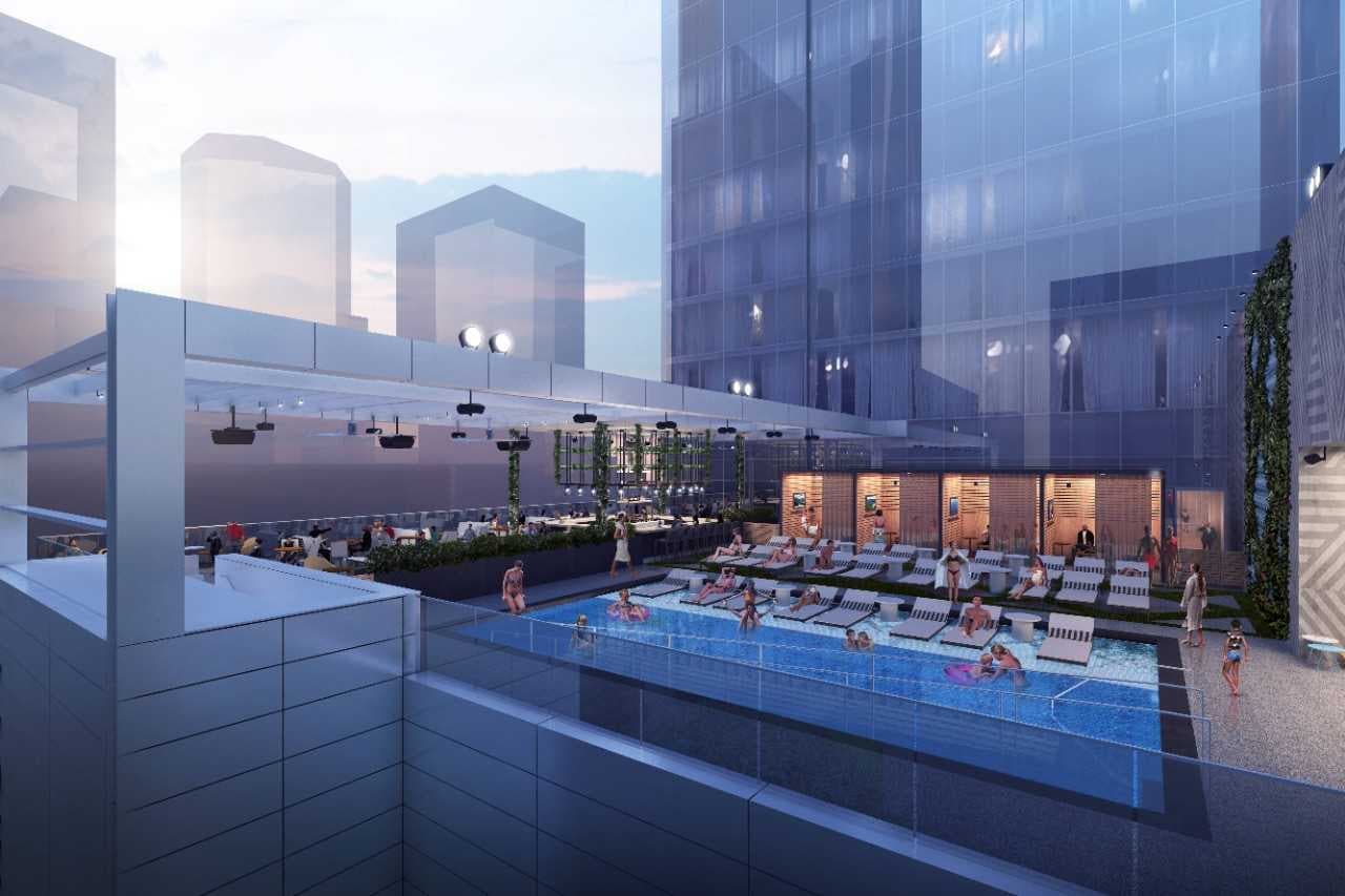 Rooftop pool with seating.