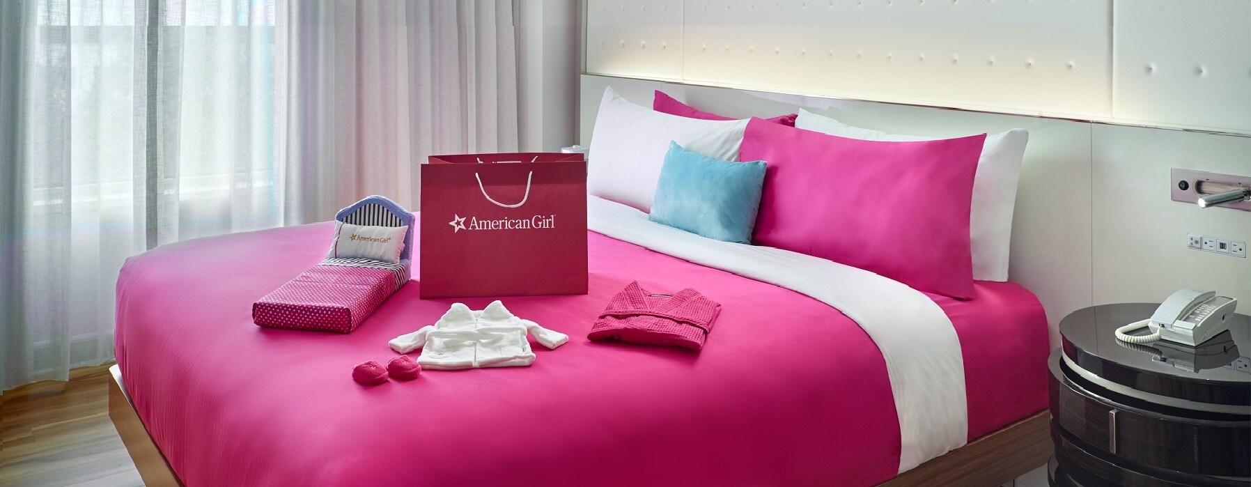 Guest room with pink American Girl decor.