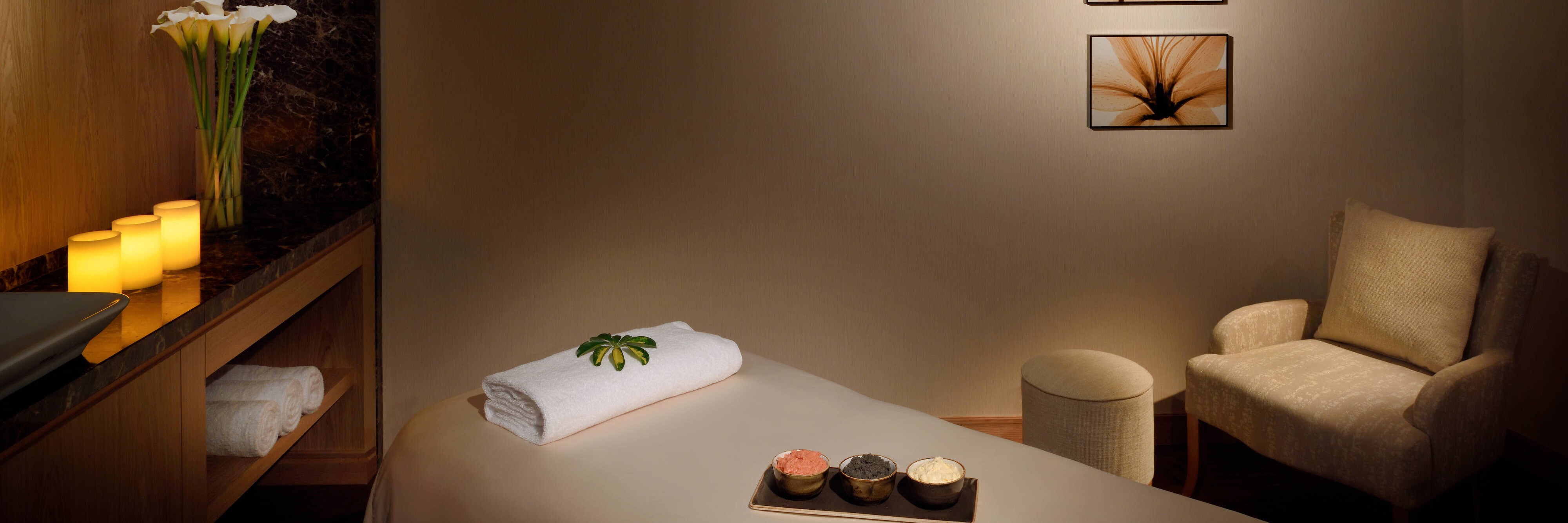 Kigali marriott spa massage room with chair, table and low lighting