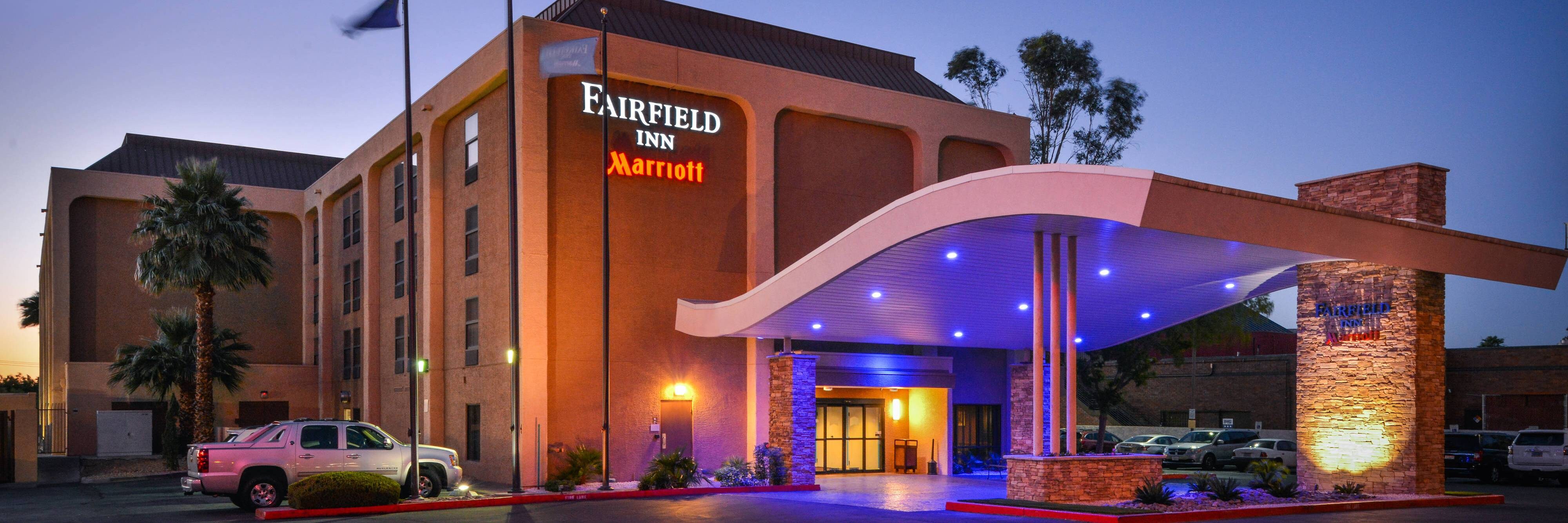 Hotel exterior lit up at dusk.