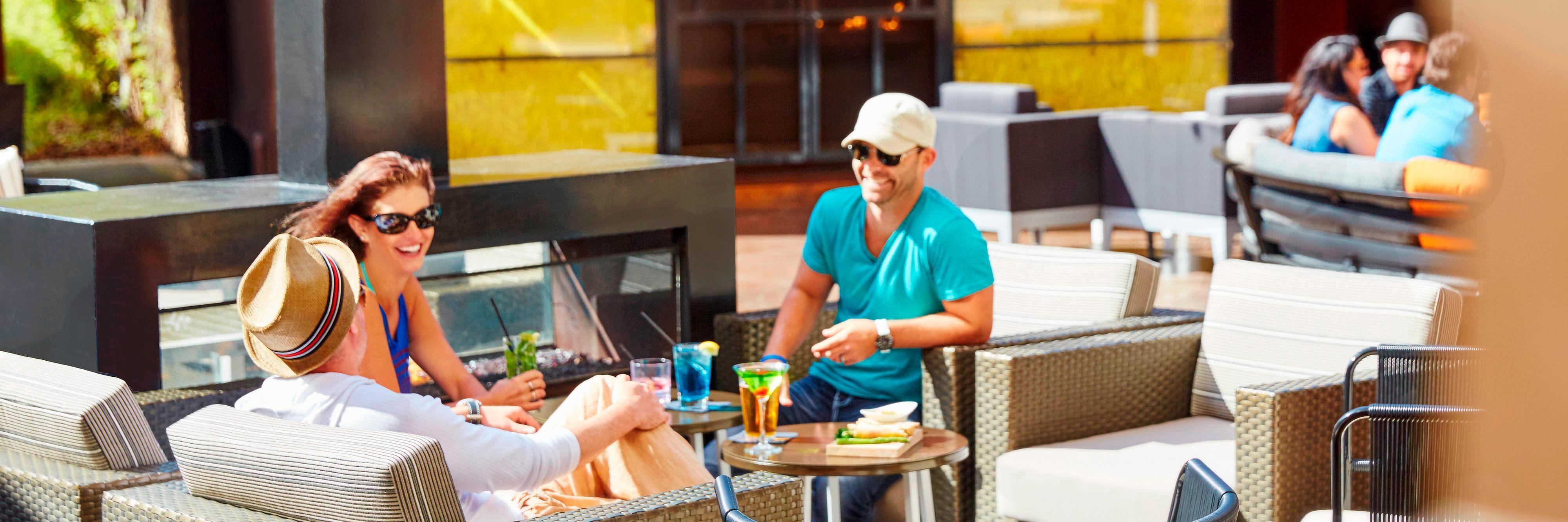 Group of people socializing outside on lounge furniture