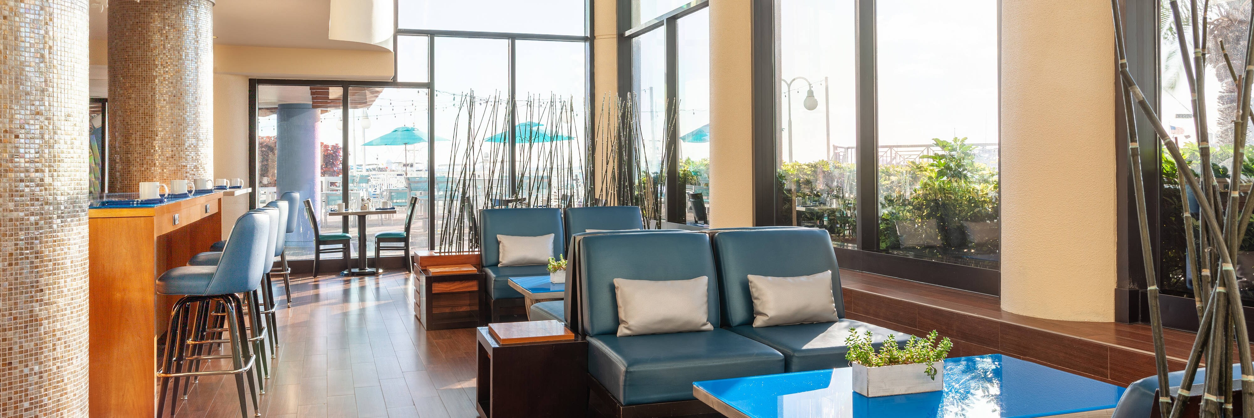 Dining room with booths and large windows facing the harbor.
