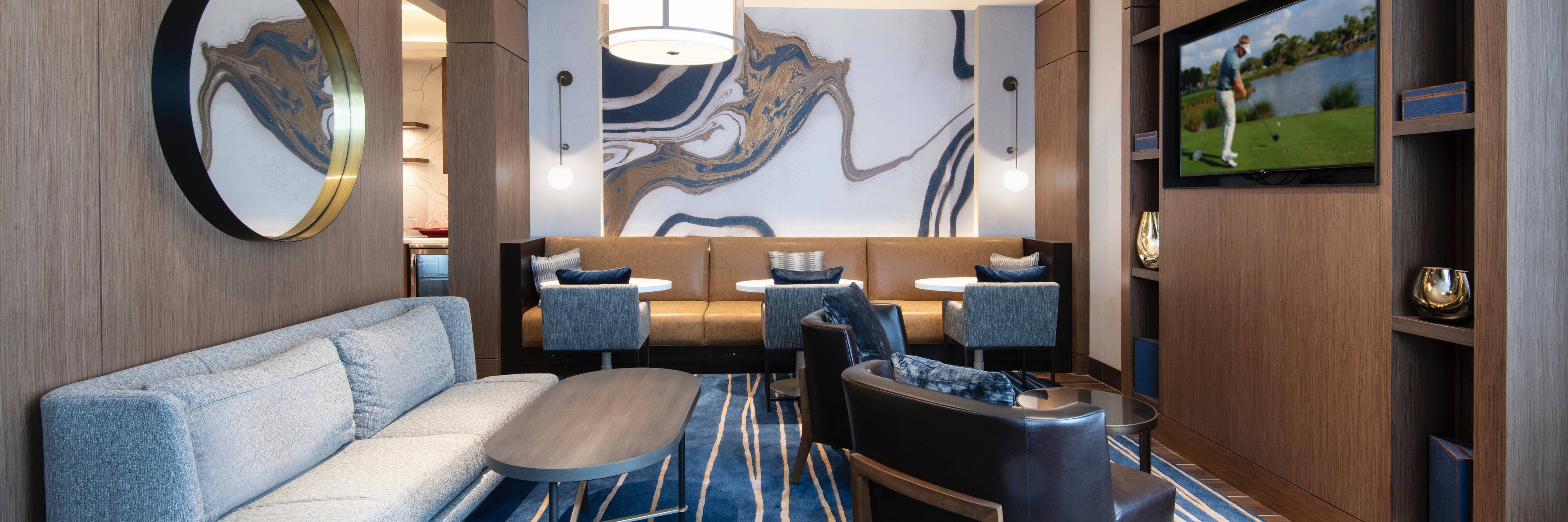 Marriott madison west mclub lounge with couch seating and flat screen tv