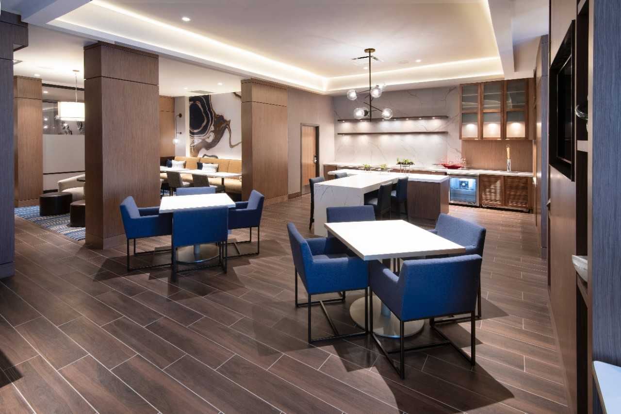 Mclub at marriott madison west with dining tables and blue accent chairs