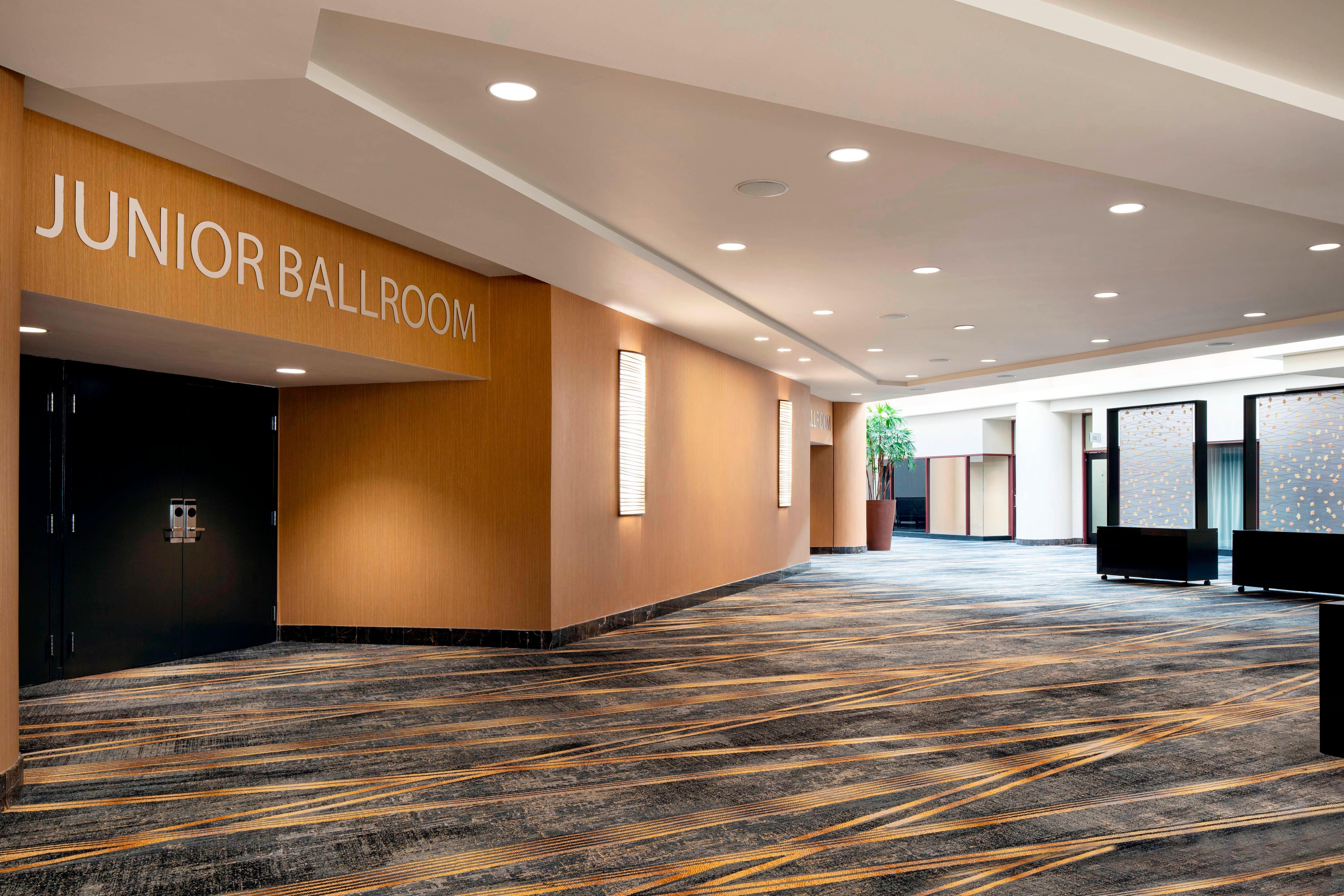 Carpeted Junior Ballroom pre-function space with recessed lighting