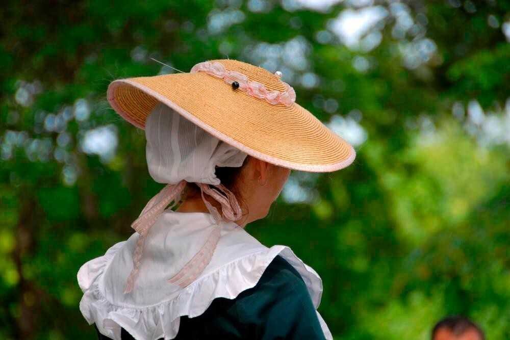 Close up of woman's Colonial Willamsburg hairstyle and costume.