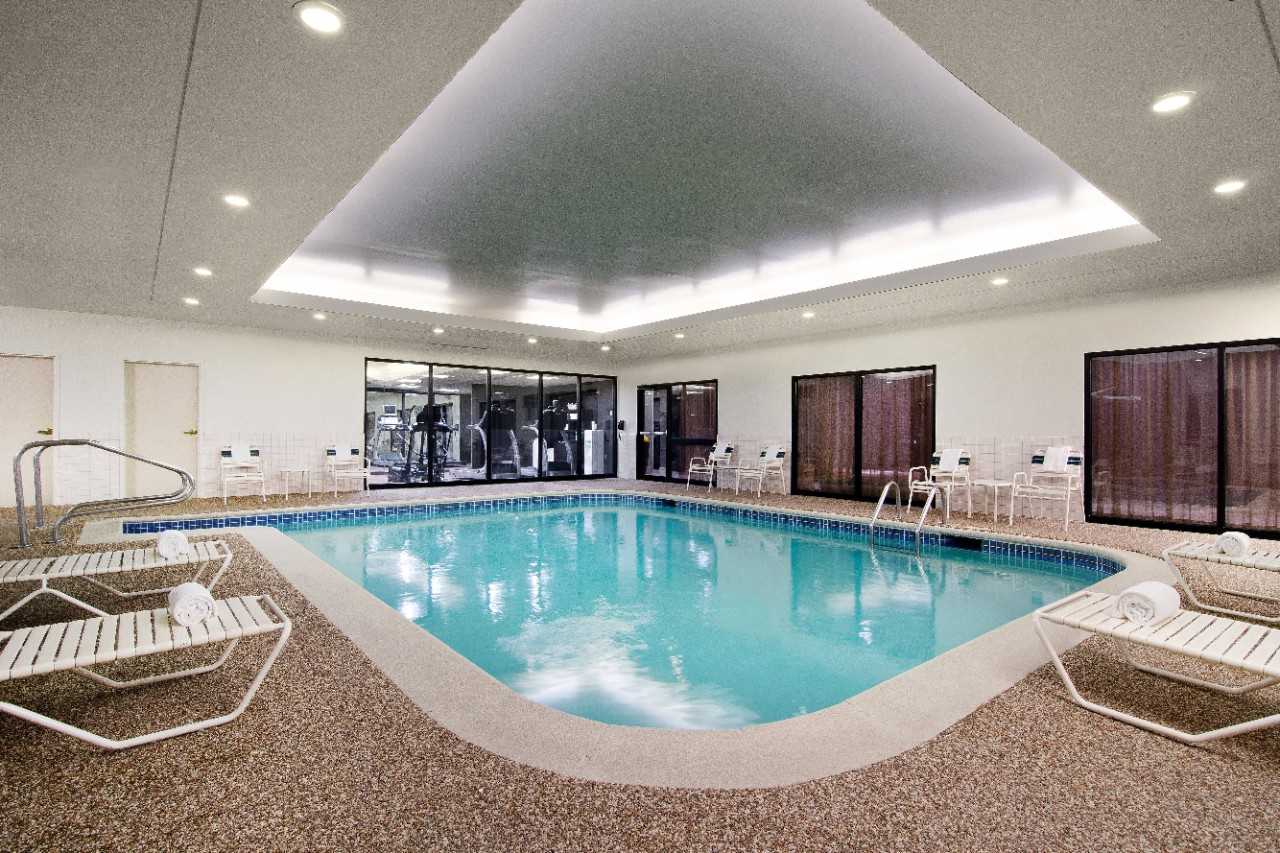 Indoor pool with deck chairs.
