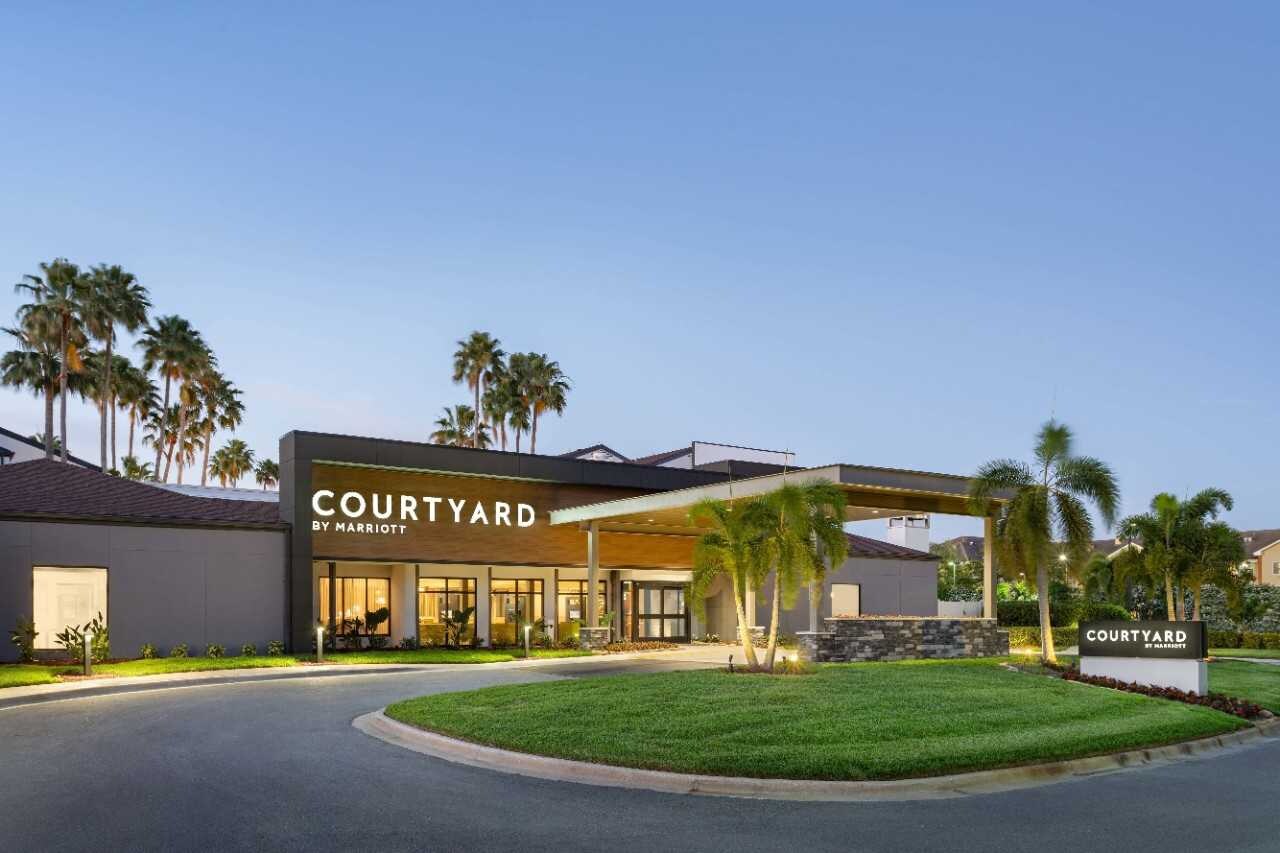 hotel exterior with circle drive and lawn