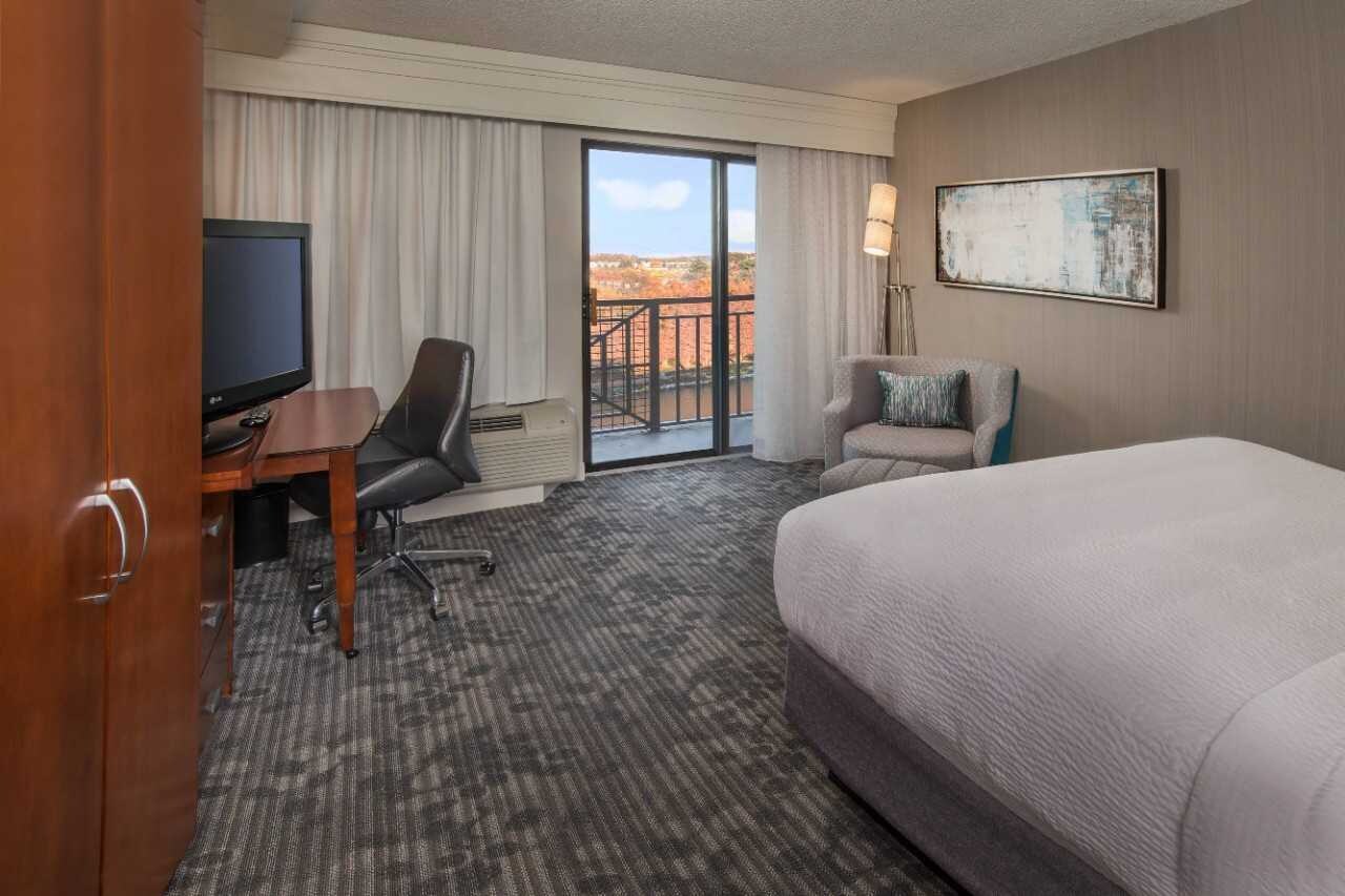 Guest room with flat screen television and exterior view.