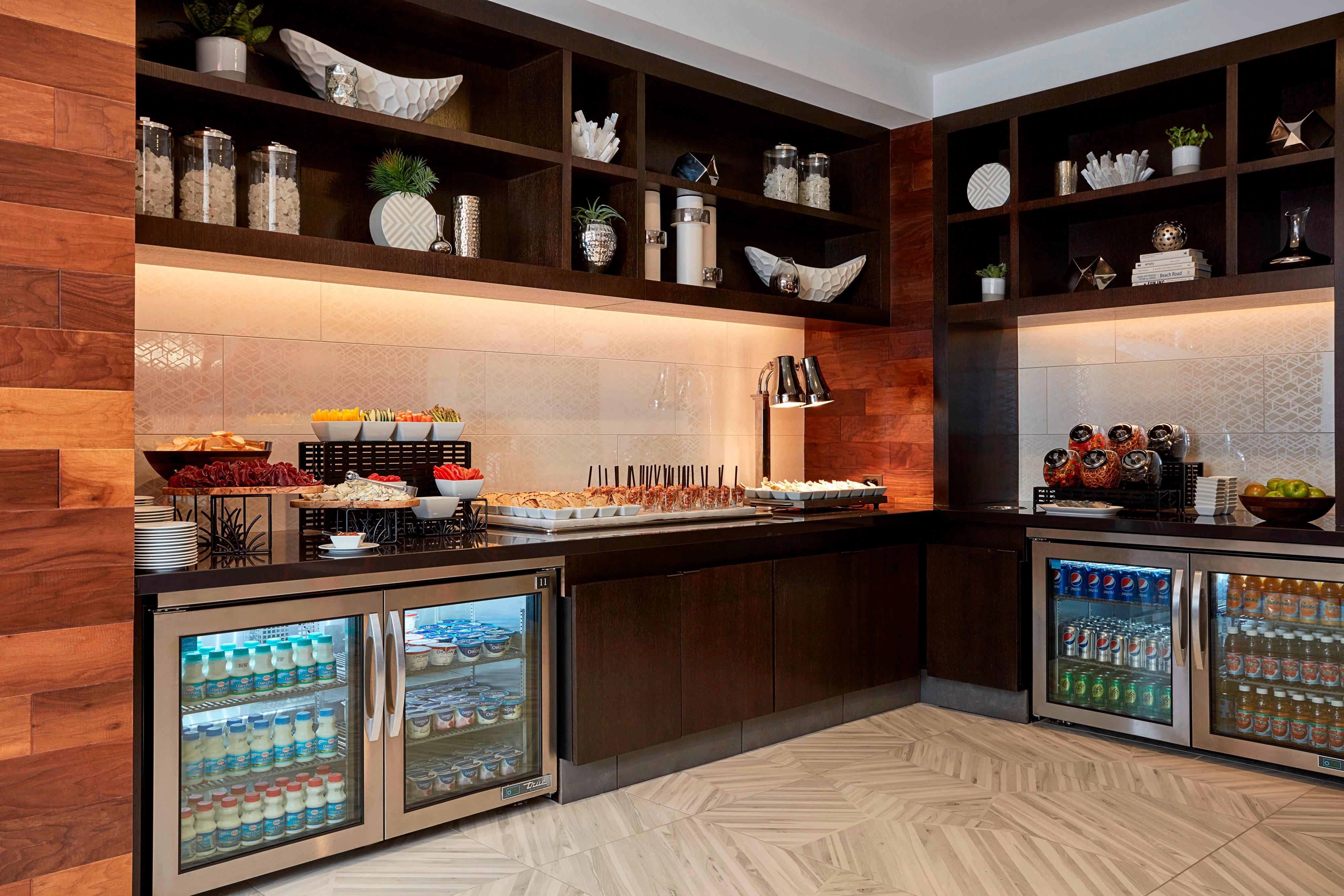  Beverage refrigerators and selection of sliced vegetables and other foods on counters