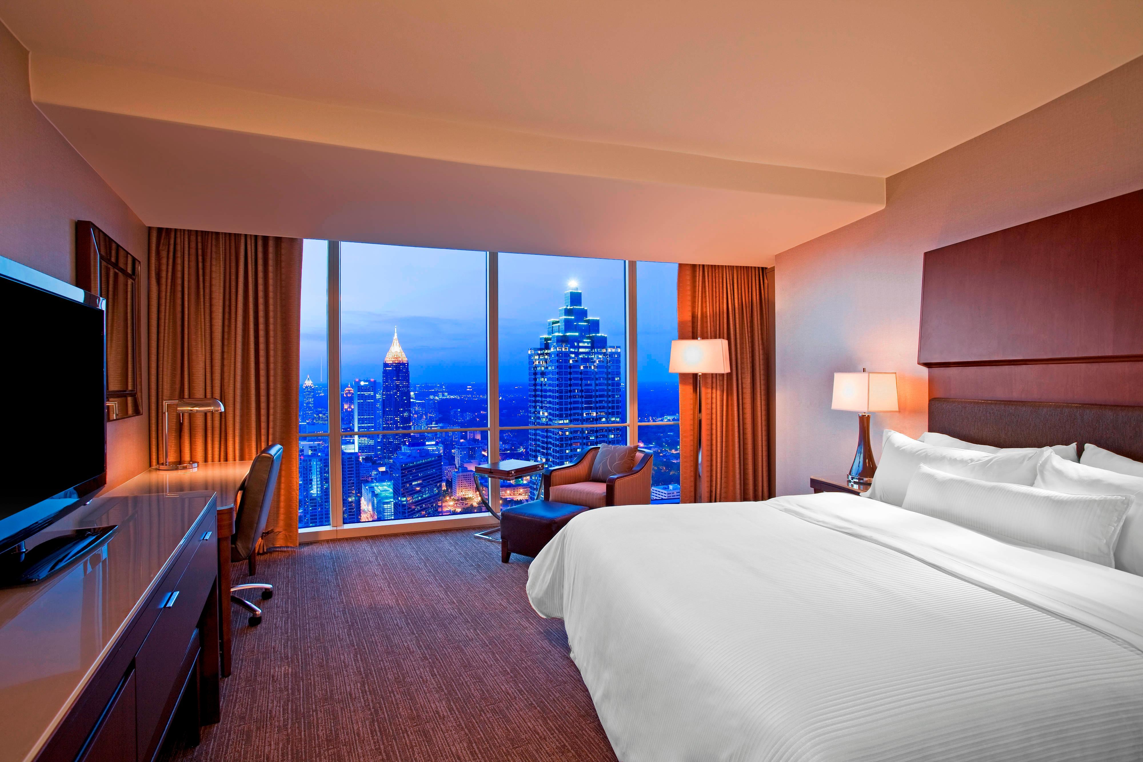 Premium king bed guest room. The Atlanta skyline is visibile from window
