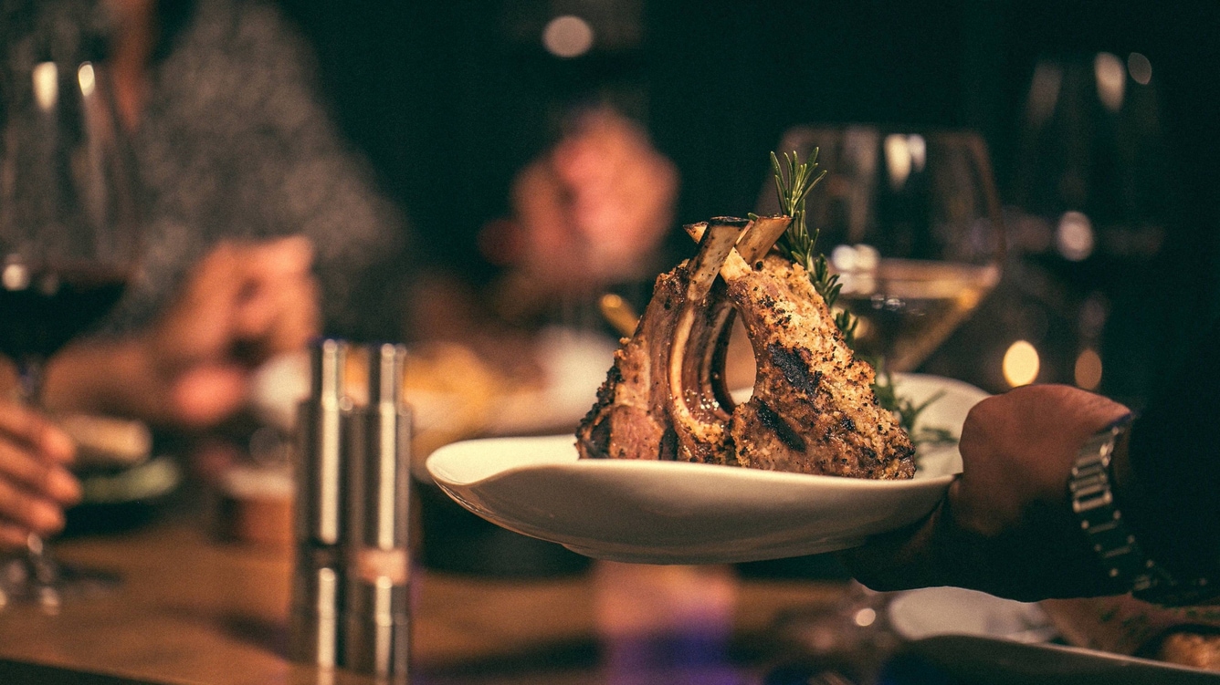 Rack of lamb with rosemary sprig.