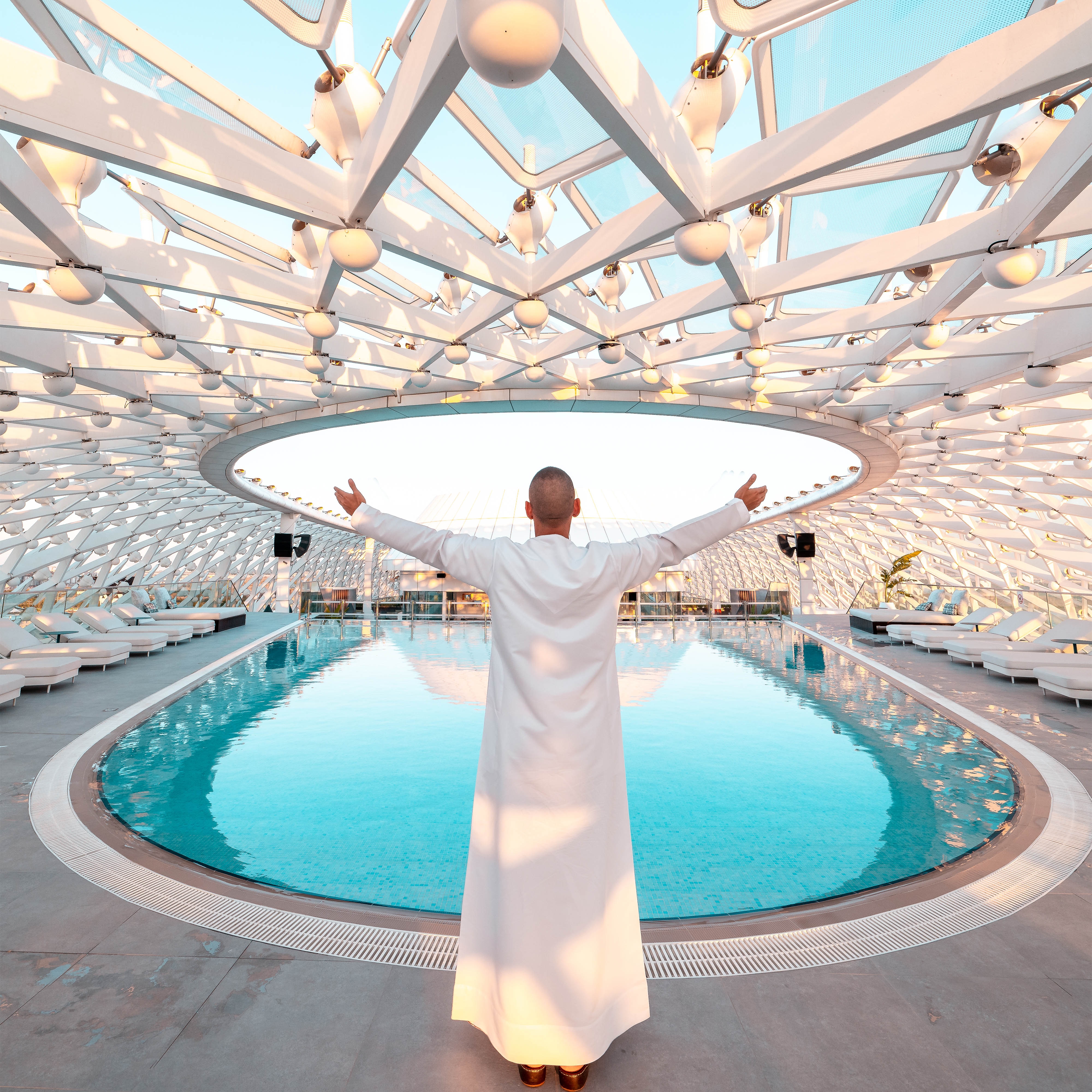 Person standing beside outdoor swimming pool