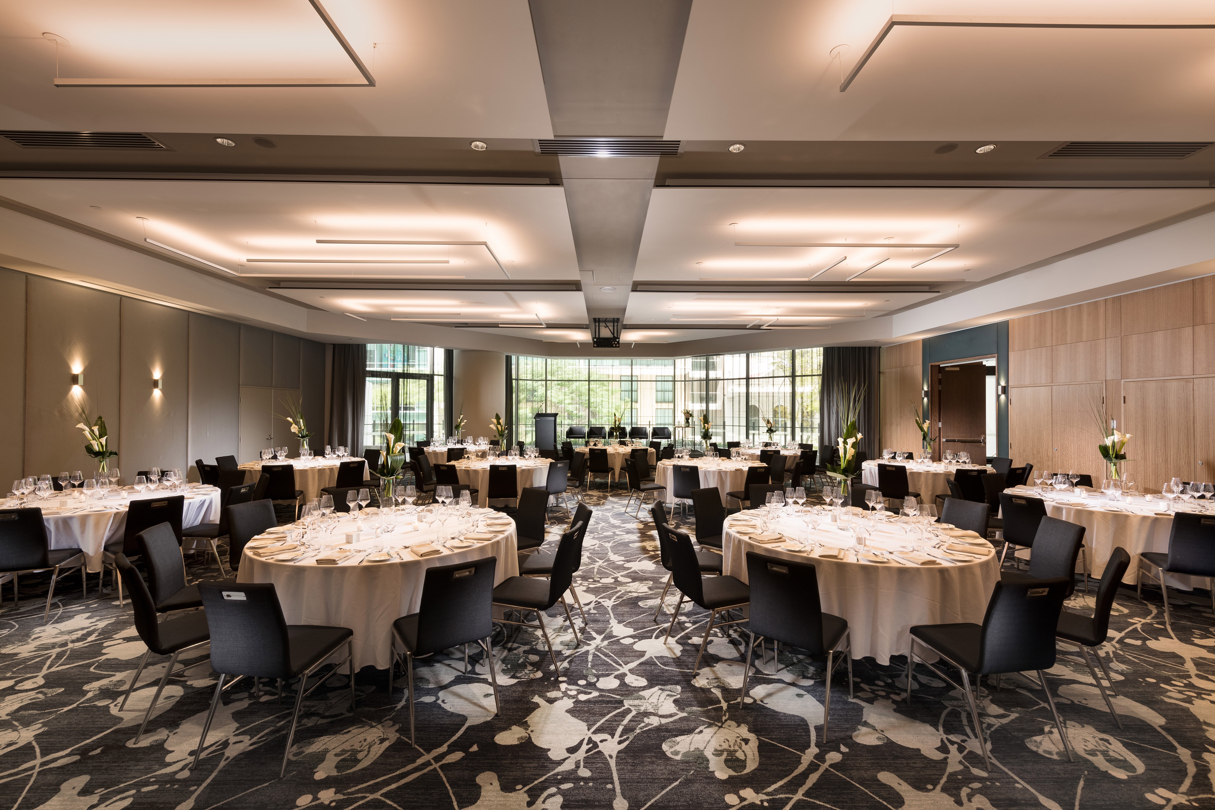 Ballroom with large windows and round banquet tables