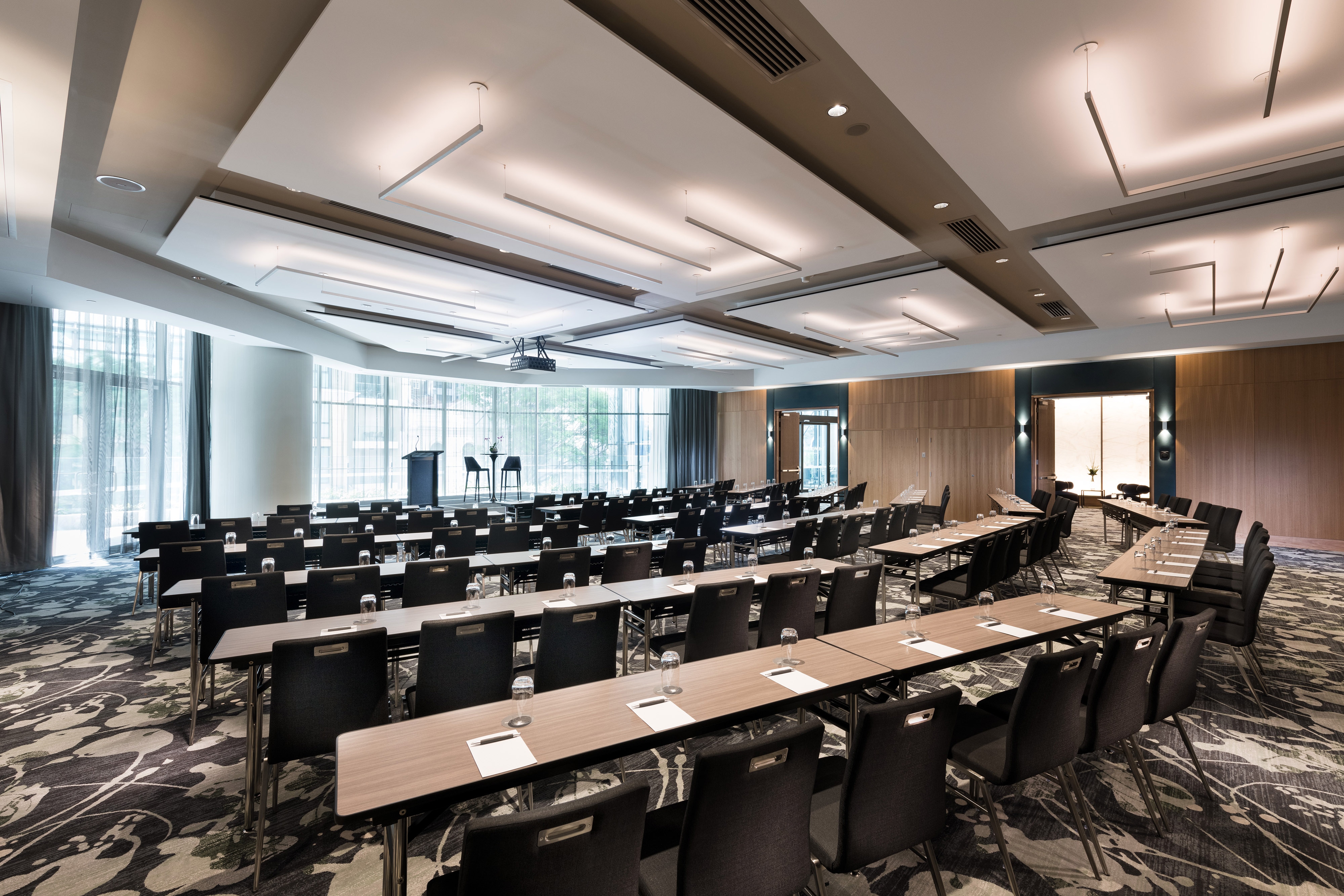 Meeting room with large windows and tables and chairs arranged in a classroom style setup