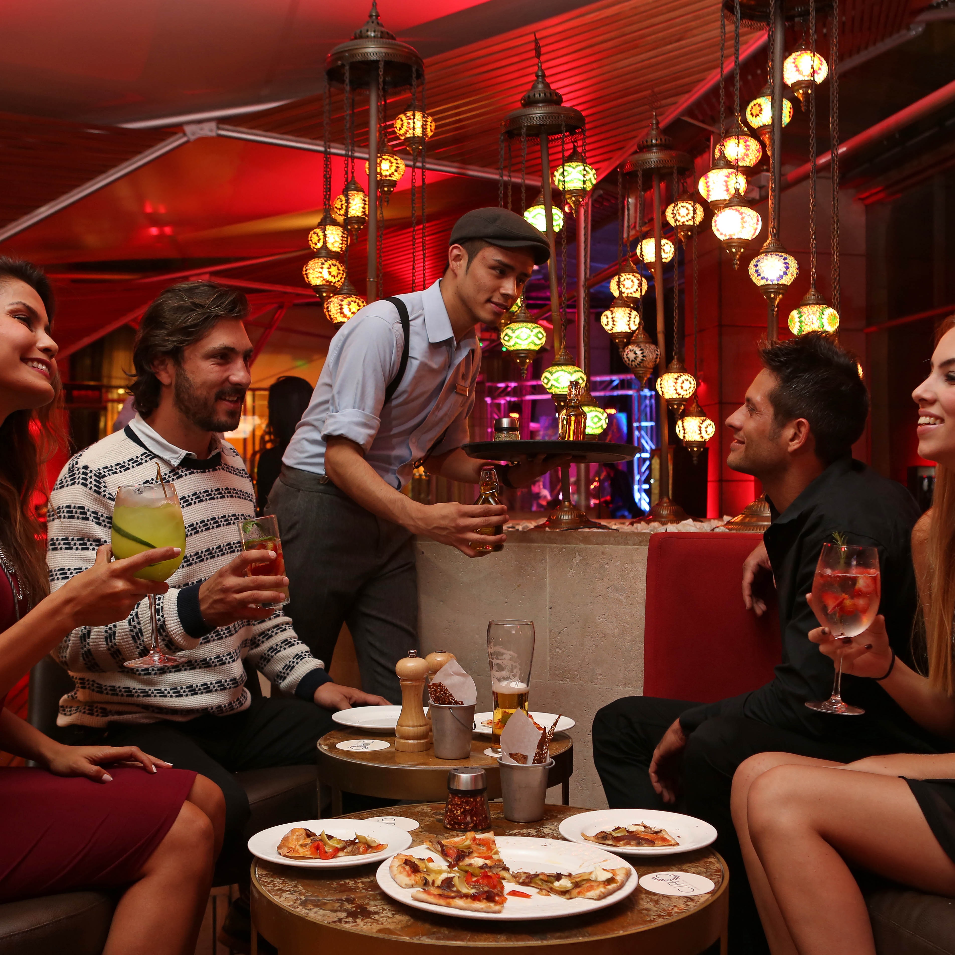 Friends enjoying cocktails at hotel bar